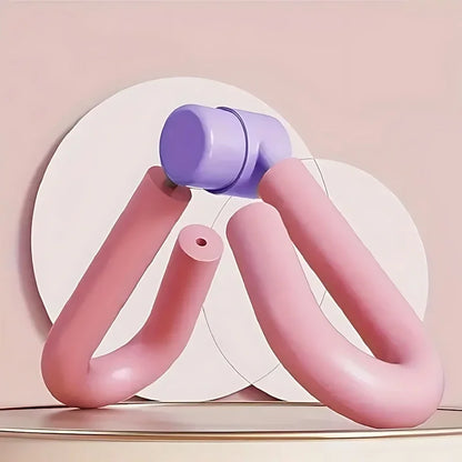 Pink and purple thigh toner fitness tool on a beige background, exercise equipment.