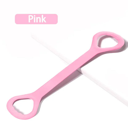 Pink silicone resistance band with looped handles on white background, fitness accessory