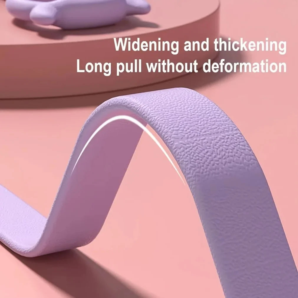 Close-up of textured purple resistance band for fitness training on a peach background.